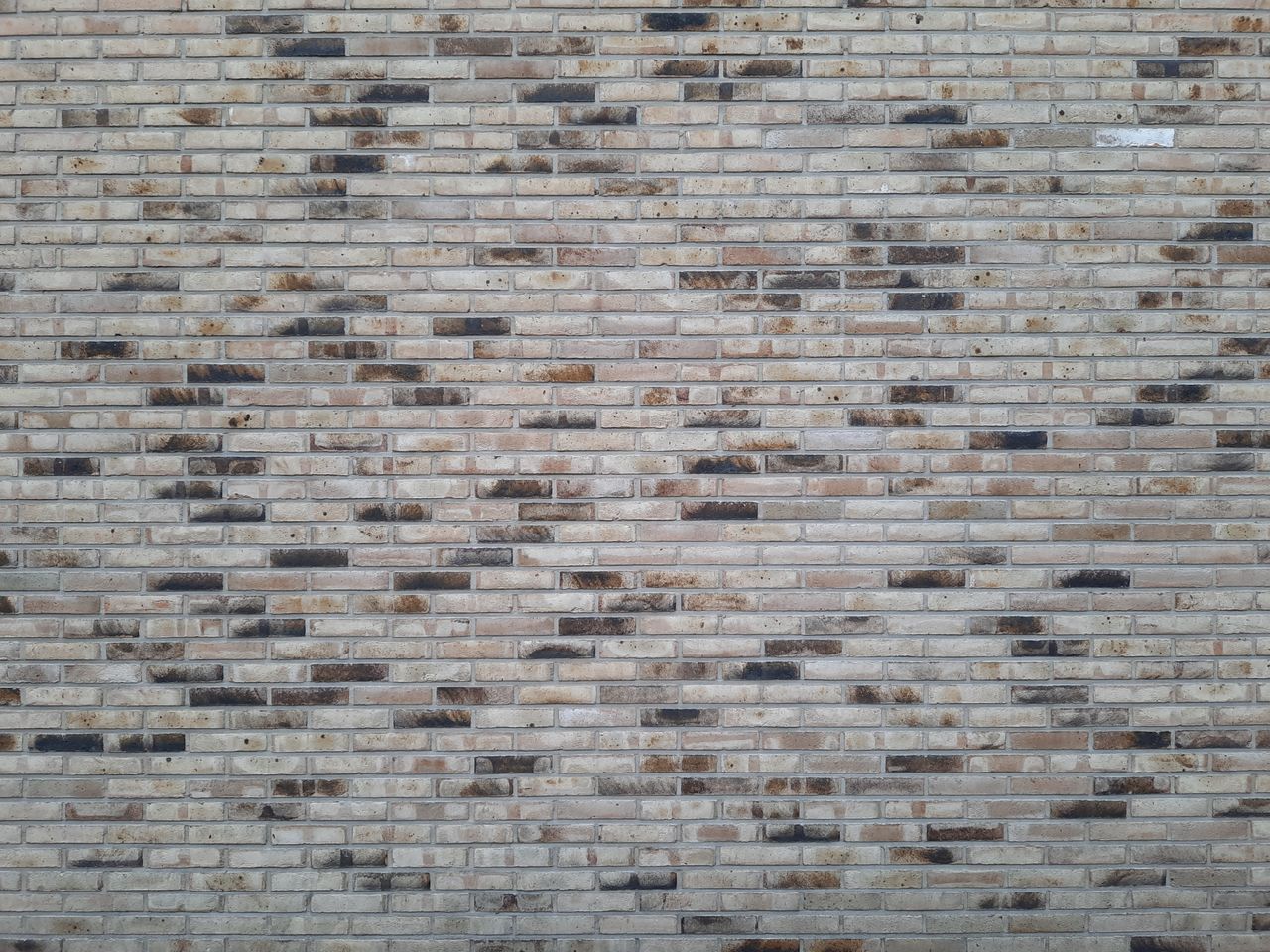 Detailed image of a textured gray brick wall, perfect for backgrounds and design use.
